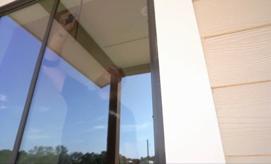 Nash Window Tint expert installing frosted window film on a glass door